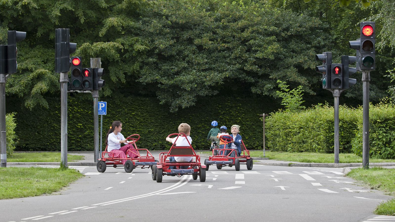 Børn leger i mooncarts på trafiklegeplads